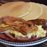 Pancakes Deluxe · With ham, bacon, sausage & eggs.