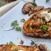 Mushroom Toast · A gluten free sourdough toast topped with a savory blend of mushrooms and cheese; finished w...