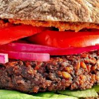 Beety Burger · Beet and walnut meat burger with baby spinach and pickled onions; served on a grainless ciab...