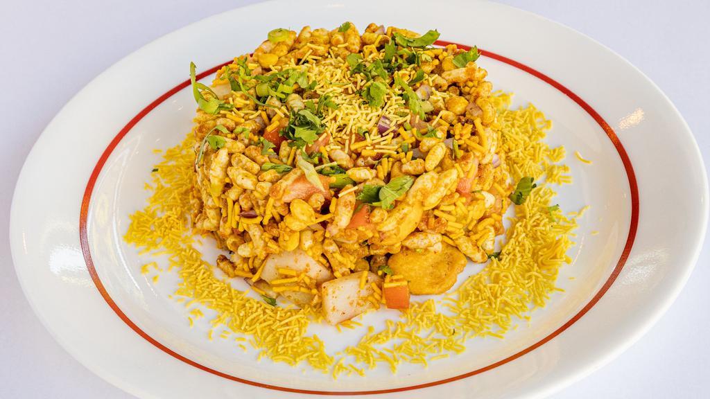 Bombay Bhel Puri · Vegetarian, gluten free. A tangy mixture of sev (lentil noodles), papdi(Indian short crust thin pastry) puffed rice, diced potatoes, onion, tossed with tamarind, mint chutney, mango powder and cilantro.