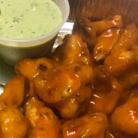 Buffalo Cauliflower Wings · Crispy Battered Cauliflower tossed in Buffalo Sauce. Served with Ranch & Celery