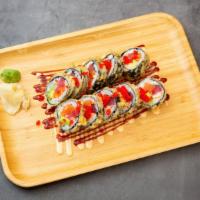 Godzilla Roll · Tuna, salmon, kani, avocado, seaweed outside, topped w/sweet sauce, spicy mayo, & masago.