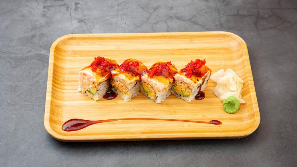 Lava Roll · Spicy kani, avocado, mango inside, topped with salmon, sweet sauce, spicy mayo and caviar toasted.