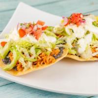 3 Tinga Tostadas  · Open shell fried tortilla topped with black refried  beans; pulled chicken marinated with ch...