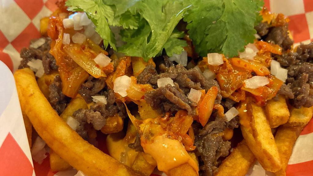 Kimchi Bulgogi Fries · Pan stirred kimchi, bulgogi and french fries topped with chopped onion, cilantro and spicy Mayo.