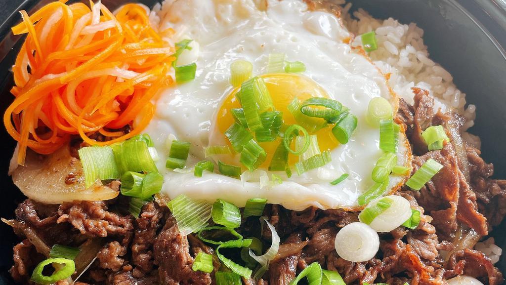 Bulgogi · Soy sauce marinated ribeye over white rice. Served with fried egg and pickled vegetable