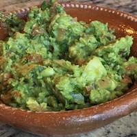 Guacamole · Mashed avocado, tomatoes, chopped onions, cilantro, and spices.