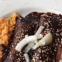 Enchiladas Mole Poblano · Soft corn tortilla with chicken, covered with our special sauce.