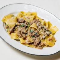 Pappardelle Con Salsiccia · sweet Italian sausage, braised endive, porcini mushrooms, herbs, truffle sauce