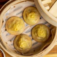 Pork & Crab Soup Dumplings · Served with our House Black Vinaigrette.