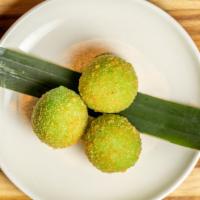 Black Sesame Balls · Savory black sesame paste wrapped with mochi & pano crust.