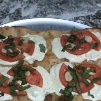 Crestino · Lightly toasted garlic bread, fresh mozzarella, fresh tomatoes, basil garlic and olive oil (...