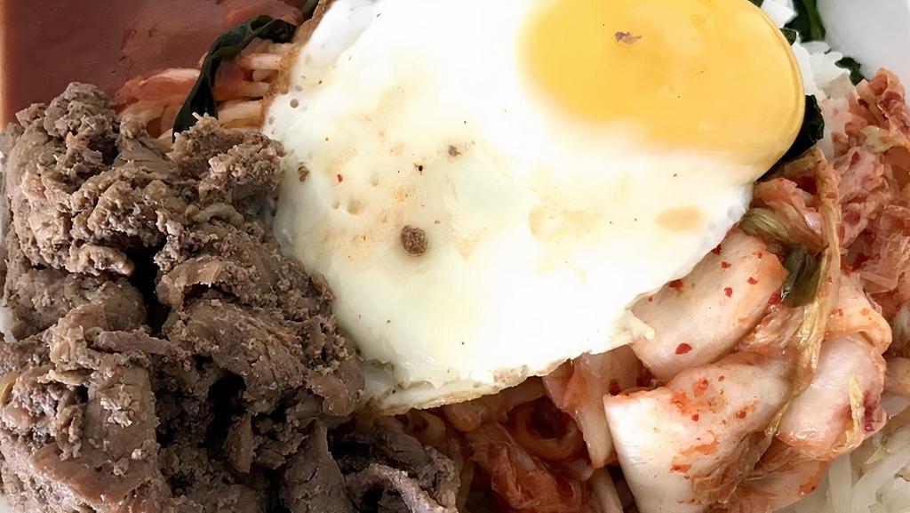 Bi Bim Bap · Beef with assorted vegetables served over rice and topped with an over easy egg. (Note: this item does not come with a choice of sides.).