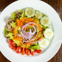 Tossed Salad · Iceberg lettuce, tomatoes, cucumbers, onions, olives, and mushrooms