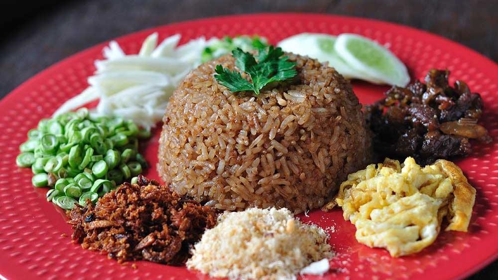 Khao Klook Ka Pi · Jasmine rice seasoned with fermented shrimp paste, served with shredded eggs, barbecued pork, and green mango.