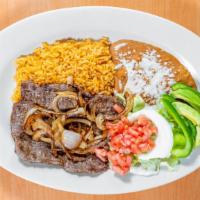 Carne Asada · Sirloin fillet steak grilled to perfection, served with rice, beans, lettuce, tomato, sliced...