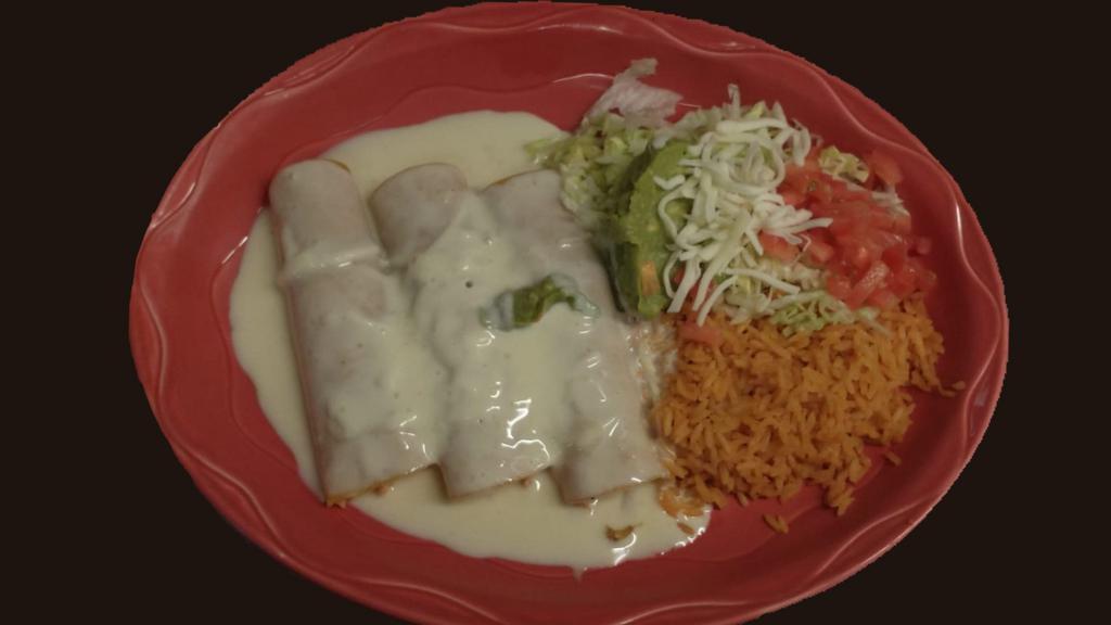 Mexico Enchiladas · Three chicken enchiladas with cheese sauce, Mexican rice and guacamole salad.