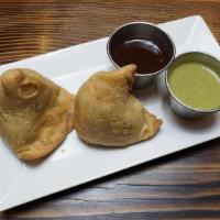 Samosa - 2 Pcs · Triangular turnovers filled with a green pea & potato mixture then fried till crispy