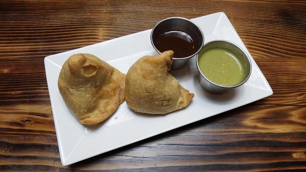 Samosa - 2 Pcs · Triangular turnovers filled with a green pea & potato mixture then fried till crispy