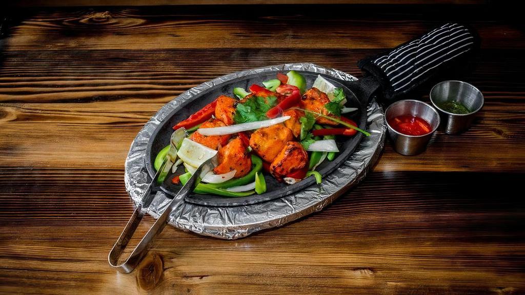 Chicken Tikka · Boneless pieces of chicken marinated overnight and cooked in a Tandoor