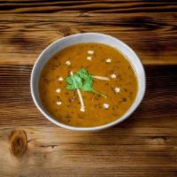 Dal Makhani · Black lentils and kidney beans cooked on low heat garnished with fresh cream