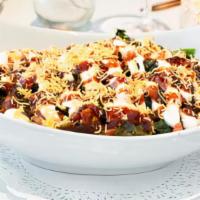 Paalak Chaat · Crispy spinach with seasoned tomatoes, red onions, sev, yogurt and tamarind chutney