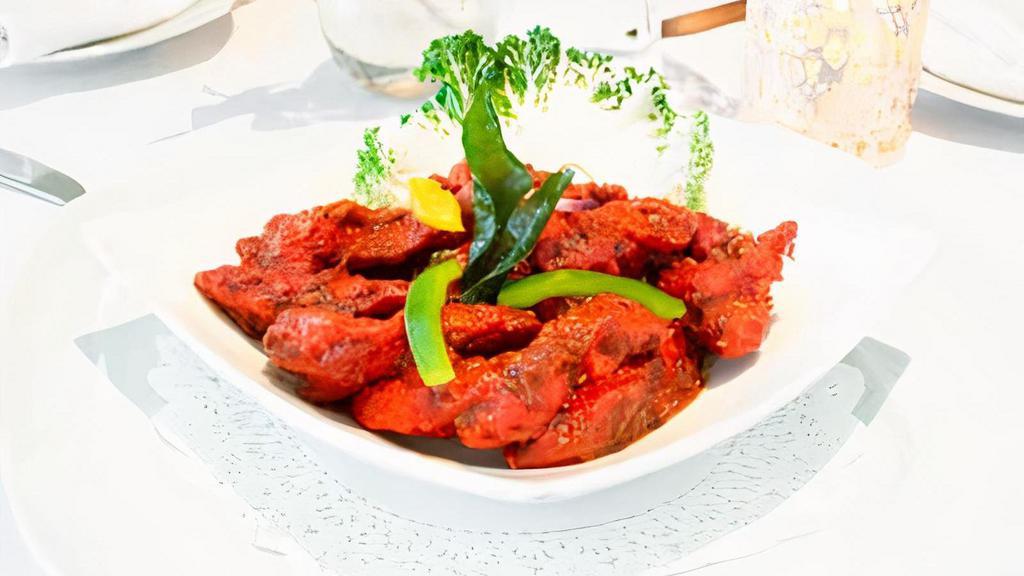 Murgh Malova · Chicken marinated in apple cider vinegar, ground pepper, curry leaves, in a fiery red chili paste
