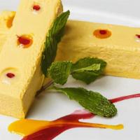 Mango Cheese Cake · Served with mango coulis and crème anglaise