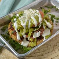 Tostadas · Filled with beans, lettuce, tomato, cheese and sour cream.