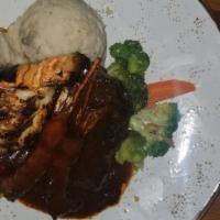 Bahamian Surf & Turf · Butter garlic lobster, jerk shrimp, and short ribs served with chunky mash yam.