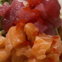 Kido Salad · Kani salad, spicy mayo, seaweed salad, tuna, salmon, yellowtail on top.