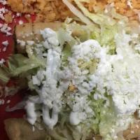Tacos Dorados (4) · Four tacos dorados with potato, beef, topped with lettuce and queso fresco.