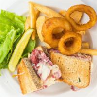 Reuben Sandwich · Corned beef with sauerkraut and swiss cheese on rye toast with Thousand island dressing.