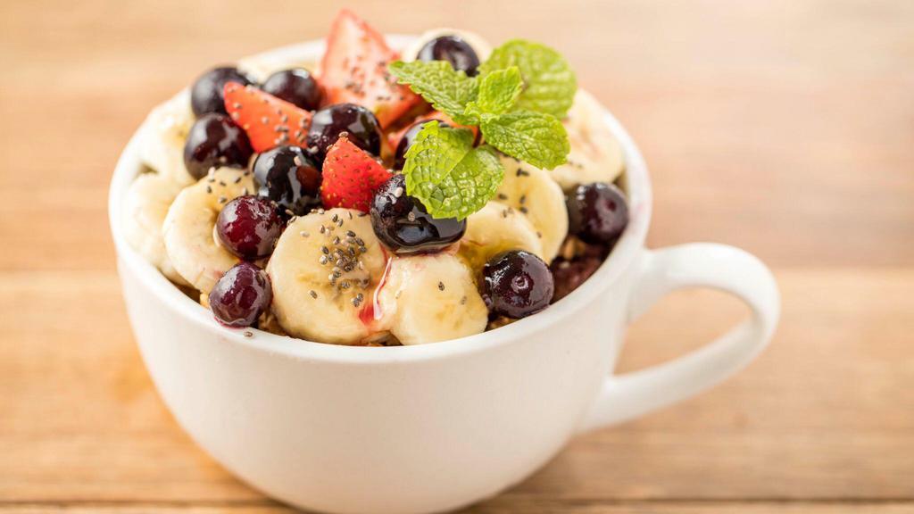 Açaí Bowl · Organic acai topped with granola, banana, strawberry, blueberries, honey, and mint