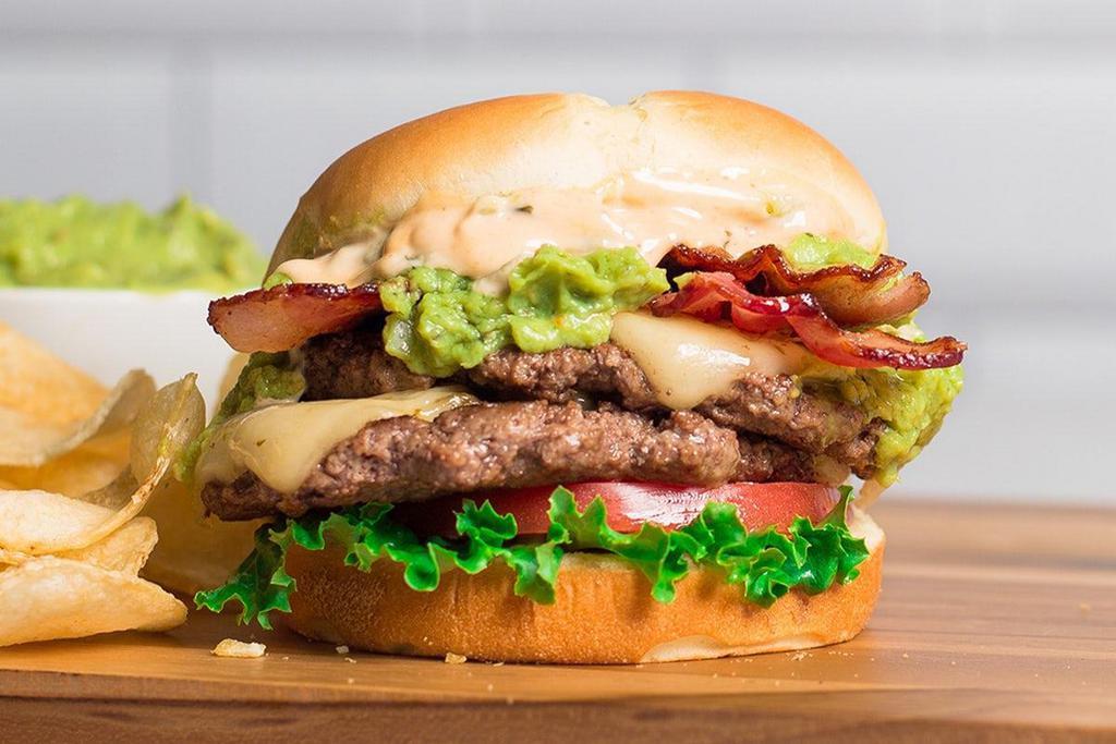 Guac Burger · Two beef patties cooked-to-order, topped with two slices of Pepper Jack cheese, bacon, lettuce, tomato, chipotle mayo and of course, zesty guacamole!
