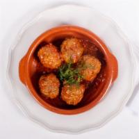 Keftedes · Greek style meat balls slow roasted in tomato sauce.