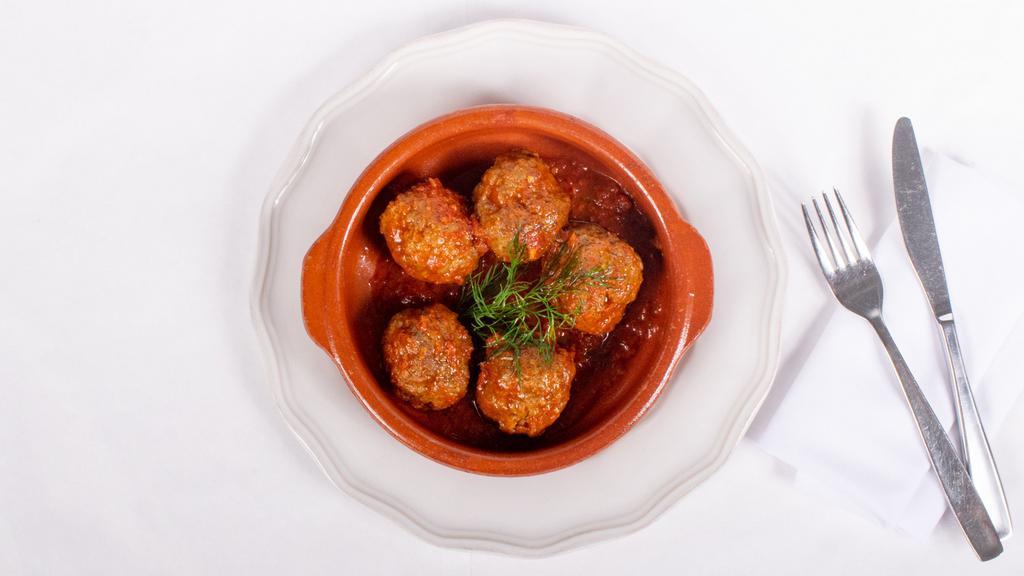 Keftedes · Greek style meat balls slow roasted in tomato sauce.