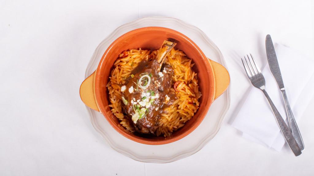 Giouvetsi Arni · Baby lamb shank oven-baked with orzo and fresh tomato sauce.