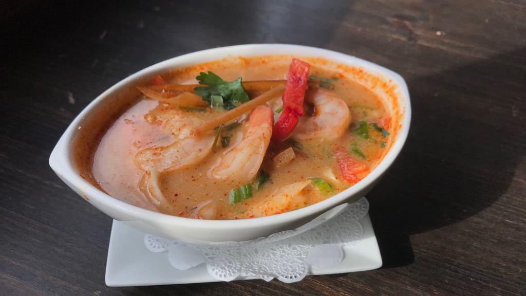 Tom Yum Soup · Spiced and sour soup with mushrooms, lemon grass, chili and kaffir lime leaves.
