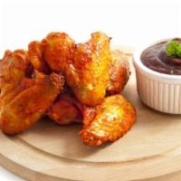 Mild Wings · Delicious chicken wings baked, then deep-fried to perfection and tossed in Mild hot sauce.