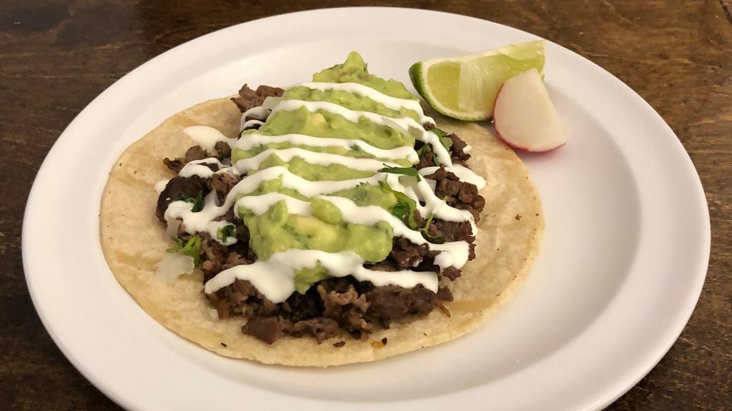 Tacos Tex · Corn tortilla topped with your choice of meat, guacamole, onions, cilantro and sour cream. Salsa on the side.