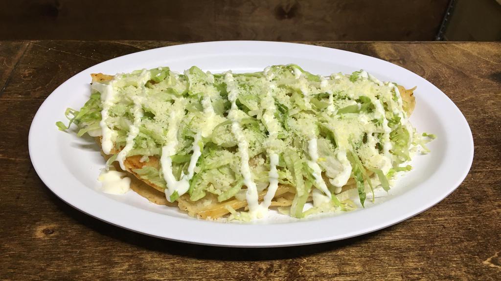 Quesadilla · Corn tortilla filled with mozzarella cheese and your meat preference topped with lettuce sour cream and grated cotija cheese.