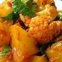 Aloo Gobi · Flavorful Potato and crispy cauliflower with herbs and spices.