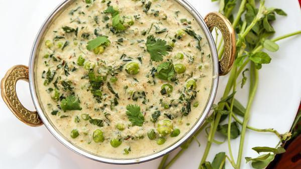 Methi Mutter · Flavorful combination of fresh fenugreek leaves and green peas.