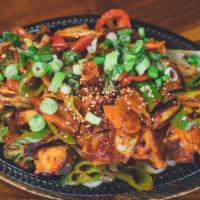 Nakji Bokkeum · Spicy stir-fried octopus and vegetables in a sweet and spicy chili sauce with udon noodles, ...