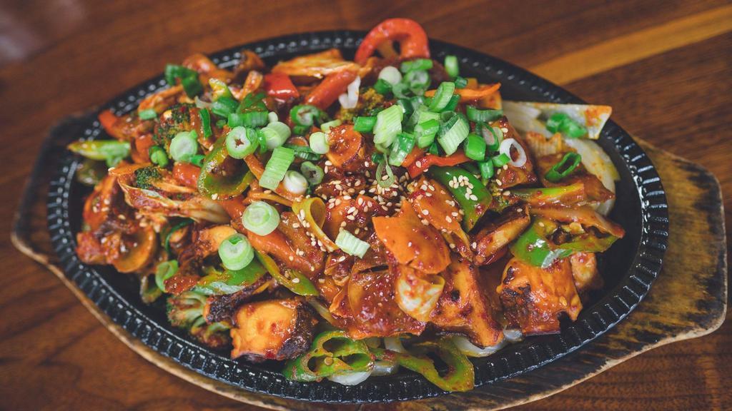 Nakji Bokkeum · Spicy stir-fried octopus and vegetables in a sweet and spicy chili sauce with udon noodles, served with a side of Dokebi rice
