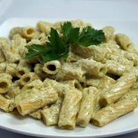 Penne Alla Pesto · Penne pasta in a pesto cream sauce, topped with grated cheese.