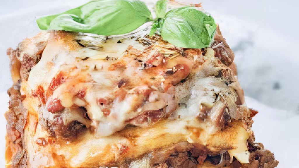 Baked Meat Lasagna · Layered pasta with ricotta, ground beef, fresh tomato sauce topped with melted mozzarella.