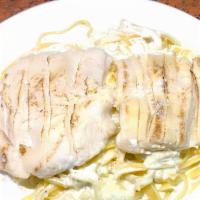 Fettuccine Alfredo With Grilled Chicken · Fettuccine pasta in a creamy Alfredo sauce topped with sliced grilled chicken.