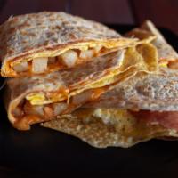 Breakfast Dilla · Egg omelet, melted cheddar jack cheese and cajun home fries, grilled and folded on a flour t...
